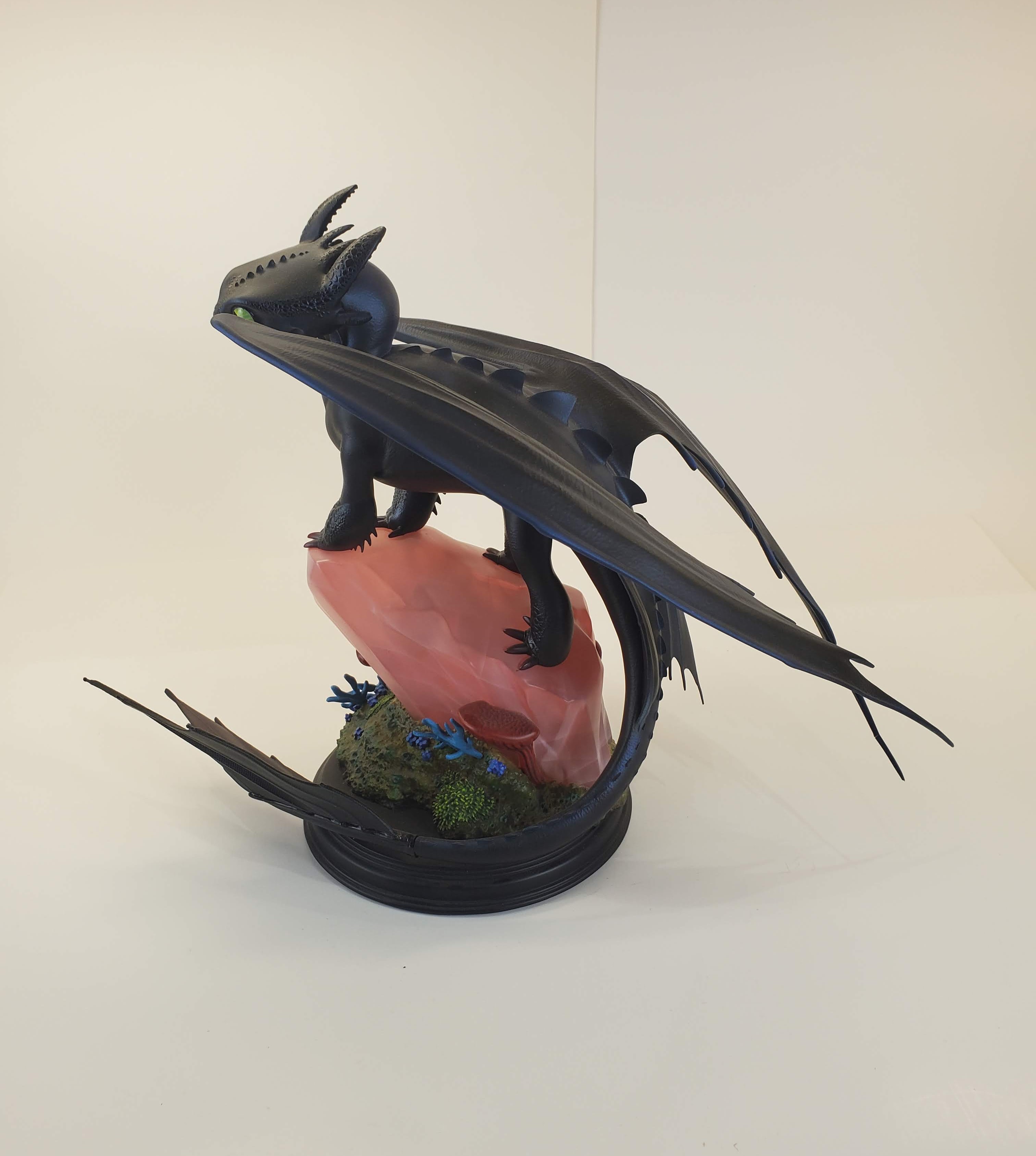 Toothless from How to Train Your Dragon, perched gracefully on a pink rocky base