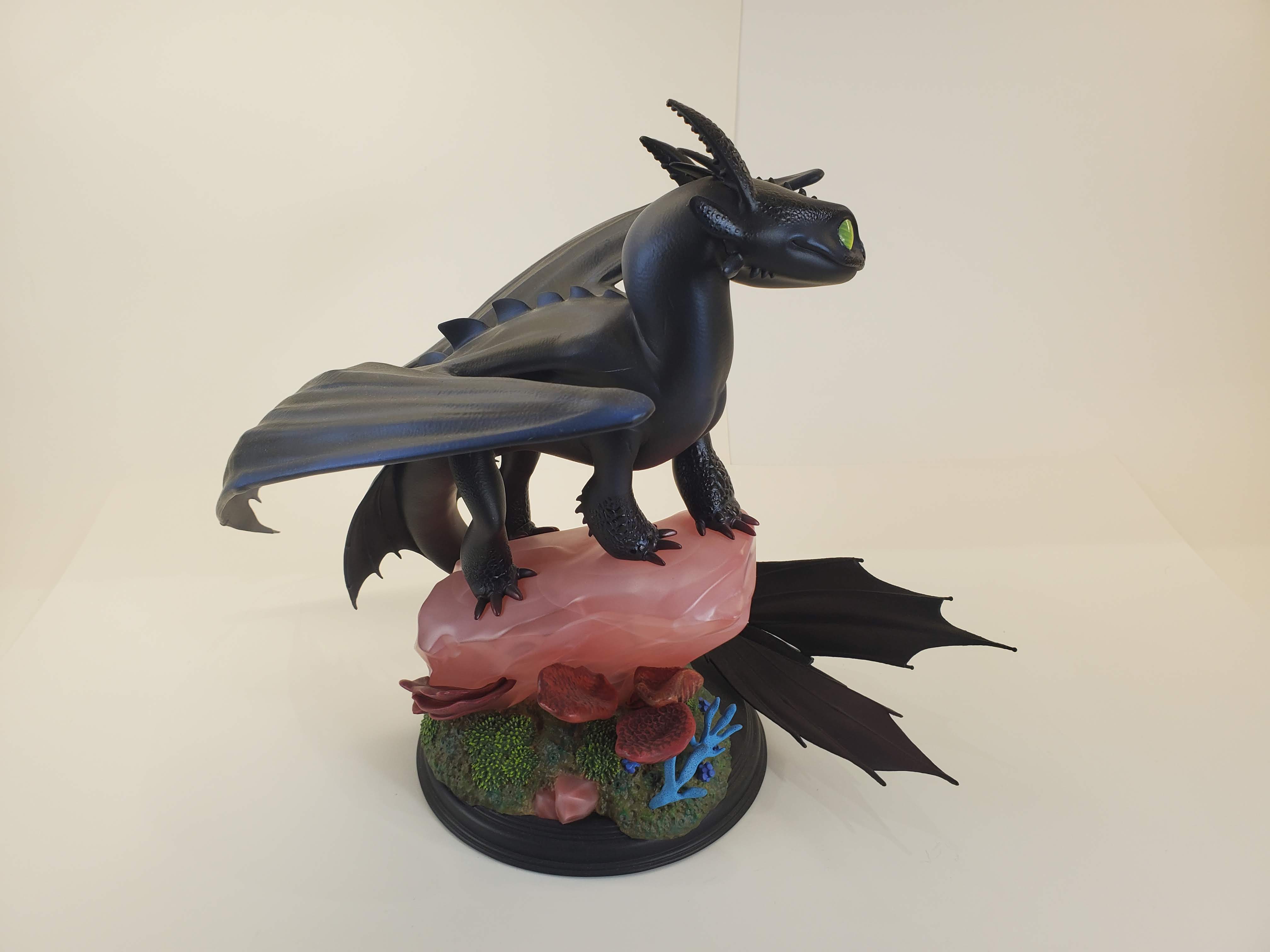 Toothless from How to Train Your Dragon, perched gracefully on a pink rocky base